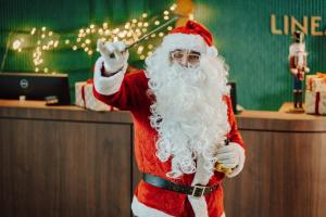 a man dressed as santa claus holding a wand at Hotel Linea Mare in Pobierowo +218 photos