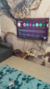 a computer monitor on a wall with a map at Tanglin Tower with Netfix by AquHome in Surabaya