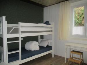 a white bunk bed in a room with a window at La Source - 85 m2 & terrasse privée in Orcival