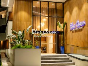 a lobby of a building with stairs and a sign at Blue Ocean Tofo Hotel & Resort in Inhambane +54 photos