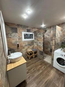 a bathroom with a sink and a washing machine at leverest rooms in Marseille +14 photos