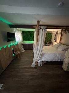 a bedroom with a bed with a canopy at leverest rooms in Marseille