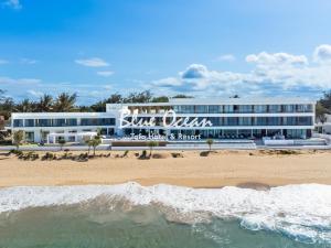a view of a hotel from the beach at Blue Ocean Tofo Hotel & Resort in Inhambane