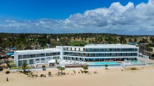an aerial view of a hotel on the beach at Blue Ocean Tofo Hotel & Resort in Inhambane
