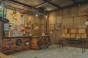 a room with a store with a counter and a table at Nipaville Haven in Moalboal