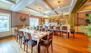 a dining room with a table and chairs at The Gateway Hotel in Swinford