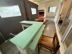a table and chairs in a tiny house at Low tide living in Struisbaai