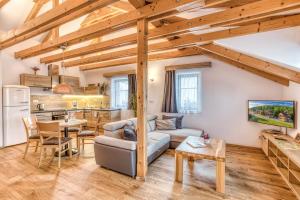 a living room with a couch and a table at Apartmány U Holubů in Rožnov pod Radhoštěm