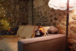 a living room with a couch and a lamp at Witch House Apartment in Rīga