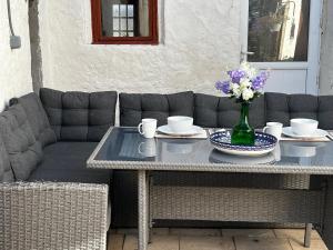 a table with a vase of flowers on it at Les Pipistrelles de Planechaud in Saint-Sornin-Leulac