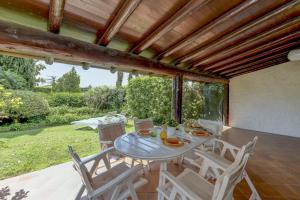 a dining table and chairs on a patio at Villa Maria by Garda FeWo in Moniga