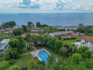 an aerial view of a home with a swimming pool and the ocean at Villa Maria by Garda FeWo in Moniga