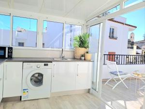 a kitchen with a washing machine and a sink at Noctua 012 Estepona Oldtown 3 in Estepona