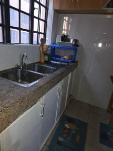 a kitchen with a sink and a counter top at Shalom Stays in Machakos