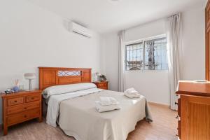 a bedroom with a bed with two towels on it at Acag 135 in Orihuela