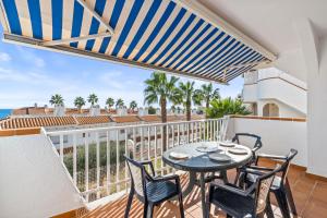 a balcony with a table and chairs and the ocean at Acag 135 in Orihuela