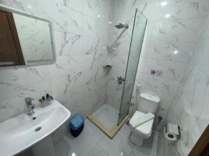 a bathroom with a toilet and a sink and a mirror at Prince Pyramids Hotell in Cairo +45 photos