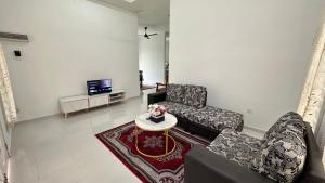 a living room with two chairs and a table at AS Suria Homestay Banglo 1 Tingkat Kota Bharu in Kota Bharu