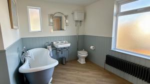 a bathroom with a sink and a toilet at 1 Bossiney House - Bude Cornwall in Bude +64 photos