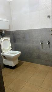 a bathroom with a white toilet in a stall at The Rain Tree resort in Kutta +35 photos