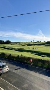 a person riding a skateboard on a golf course at 1 Bossiney House - Bude Cornwall in Bude