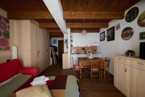 a living room with a red couch and a table at Mono 1400 in Limone Piemonte