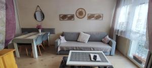 a living room with a couch and a table at Apartament Centrum in Jelenia Góra