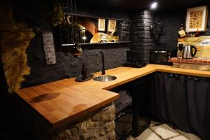 a kitchen with a sink and a wooden counter at Witch House Apartment in Rīga +17 photos