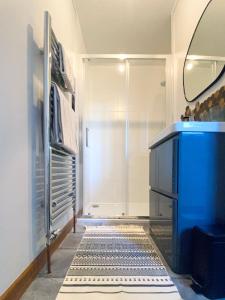 a bathroom with a shower and a blue sink at Old Church in Inverness