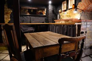 a wooden table in a kitchen with a counter at Witch House Apartment in Rīga