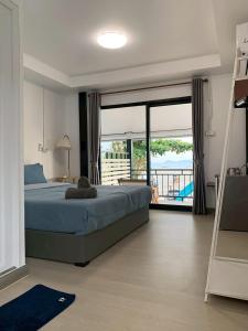a bedroom with a bed and a view of a balcony at Mook tawan Beach house in Ko Mook +53 photos