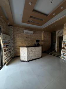 a lobby with a reception desk in a building at Prince Pyramids Hotell in Cairo