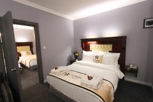 a hotel room with a large bed with towels on it at Funda Hotel in Trabzon