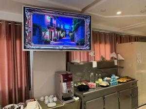 a television hanging on a wall in a hotel room at Hotel Amine in Sfax