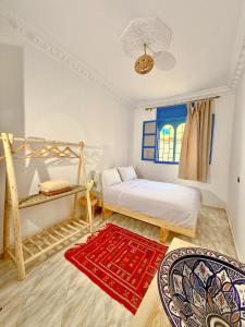 a bedroom with two bunk beds and a red rug at Onda Surf in Taghazout