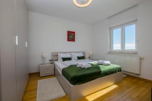 a white bedroom with a bed and a window at Apartmani BILIC in Kastav +90 photos