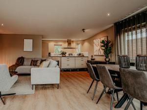 a living room with a couch and a table at Houseboat Uitgeest XL | 6 people in Uitgeest