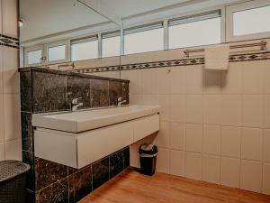 a bathroom with a sink and a mirror at Houseboat Uitgeest XL | 6 people in Uitgeest +21 photos