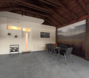 a room with a table and chairs and a window at Apartman Anita in Kupres