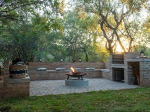 a fire pit in the middle of a patio at Nzenga Lodge in Hoedspruit
