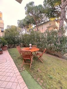 a wooden table and two chairs sitting around a table at Galliano Flexrent - Immobiliare Abissinia in Riccione