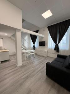 a living room with a couch and a table and chairs at Viva Residence in Calderara di Reno