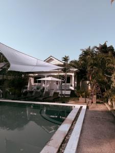 a swimming pool in front of a house with a tent at The Rai Resort Rawai - Pool & Garden in Ban Bang Chak +44 photos