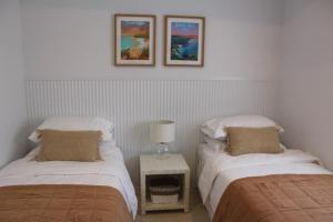two beds sitting next to each other in a room at Beach Bound-Jervis Bay in Vincentia