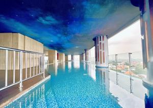 a swimming pool on top of a building with a sky at Signature 2BR Apartment ARC100 Vasa Suite Surabaya City Centre with Balcony by Le Ciel Hospitality in Surabaya