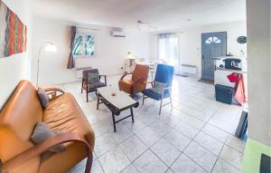 a living room with a couch and chairs and a table at Pause Nature Avec Piscine in Ferrières-Poussarou