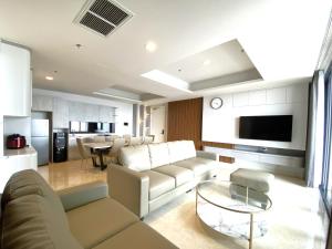 a living room with a couch and a table at Signature 2BR Apartment ARC100 Vasa Suite Surabaya City Centre with Balcony by Le Ciel Hospitality in Surabaya