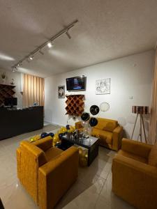 a living room with two couches and a tv at Hotel AKSA in Prizren +49 photos