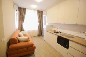 a living room with a couch and a kitchen at Hotel Caucasus in Tbilisi City +71 photos