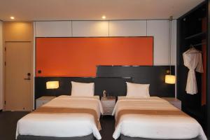 two beds in a hotel room with twothirdsessions at H-Dragon Hotel in Ðông Thôn